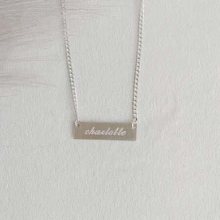 Flatlay Image of Engraved Sterling Silver Name Bar Necklace