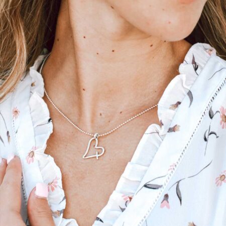 An imperfect heart hand forged in sterling silver and hung on a sterling silver chain.