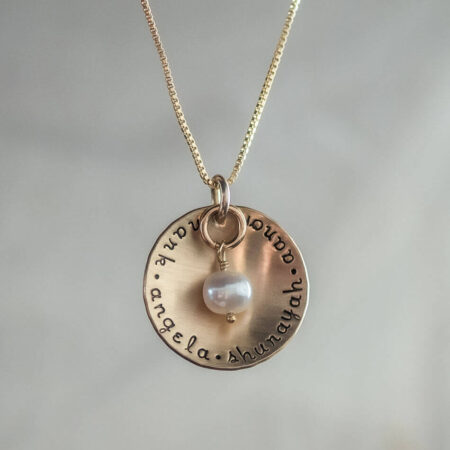 A gold disc with names hand stamped. Perfect as mothers day gift for mom, grandma