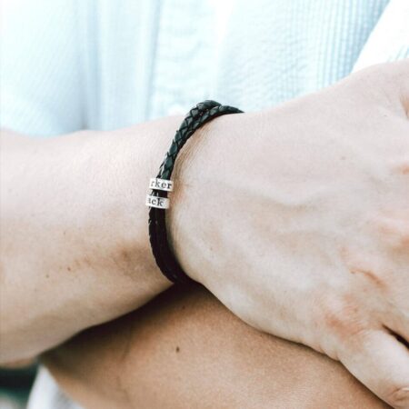 Black leather braided bracelet wrapped with sterling silver custom made rings hand-stamped with text