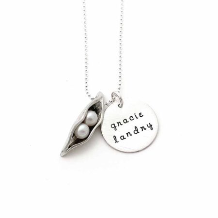 Best personalized gift for a mom. A pea pod with fresh water pearls representing her kids. A disc with names of the kids hand stamped on it.