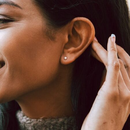 Model wearing ball stud earring